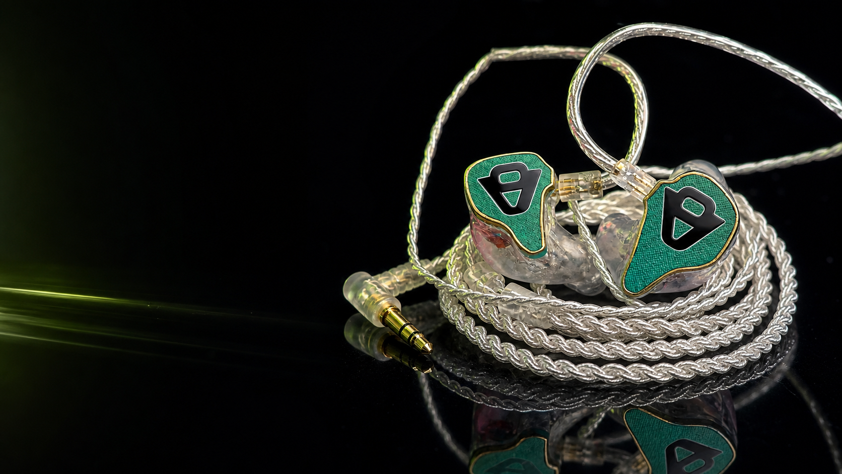 Emerald Vibe9 custom in-ear monitors with a silver braided cable