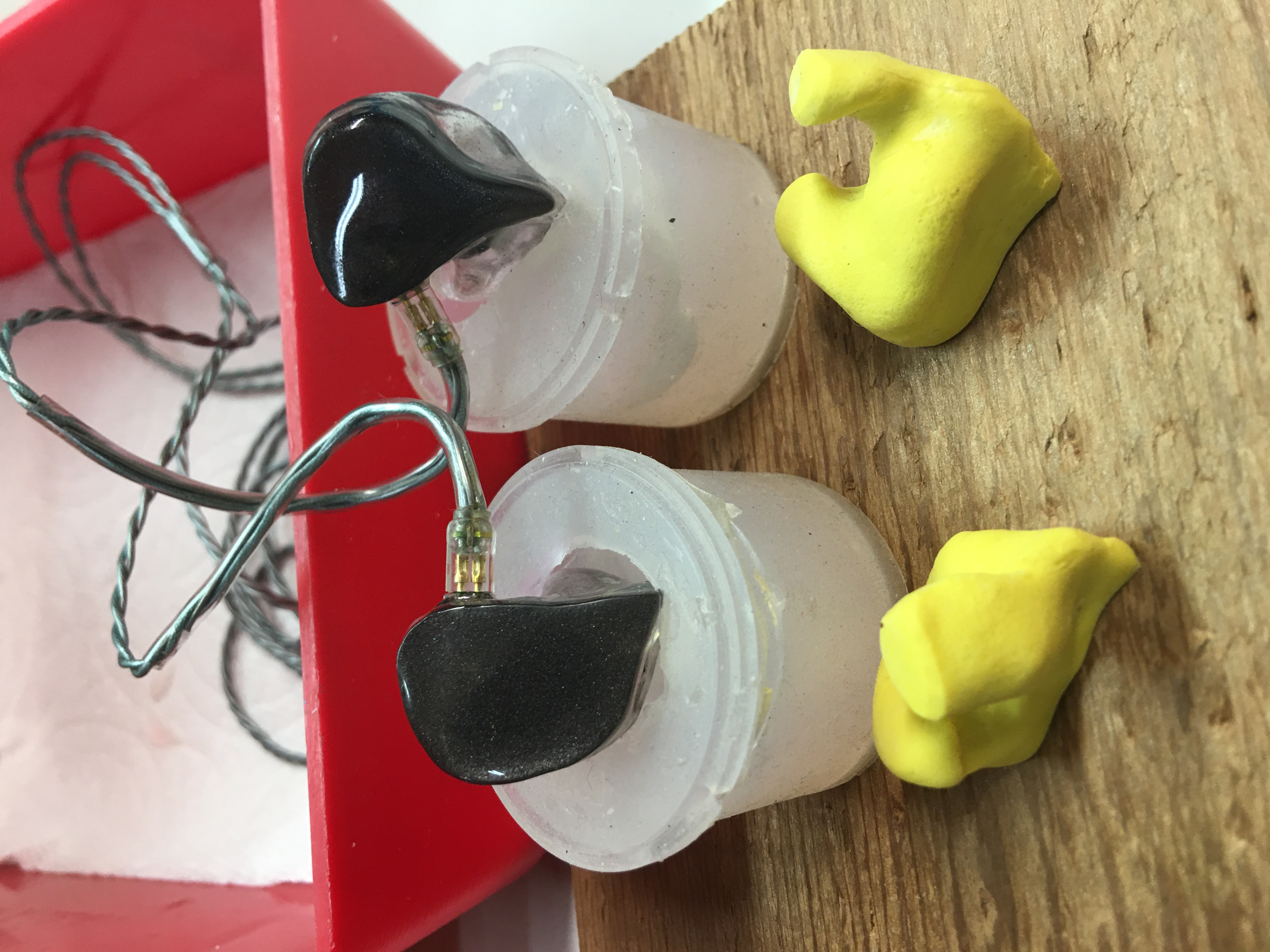 Completed custom in-ear monitors with yellow ear impressions